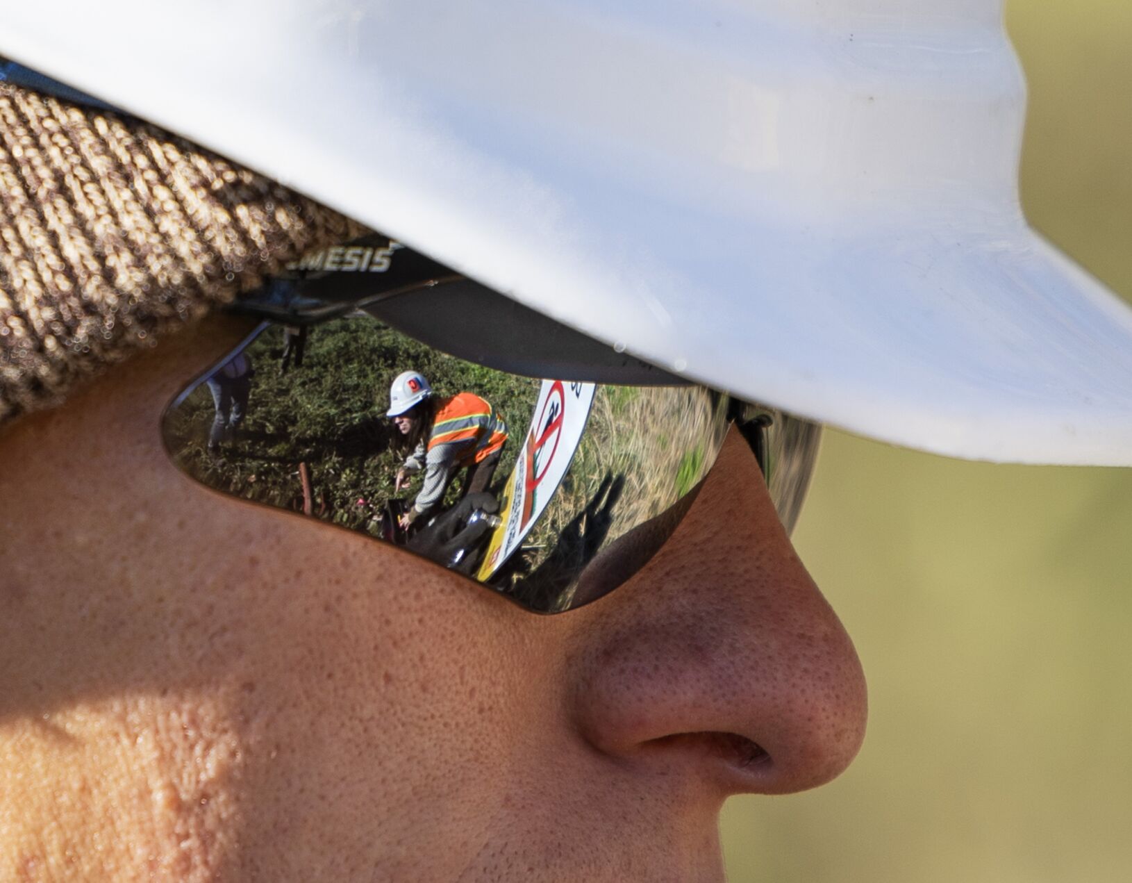 Contractors with the Army Corps of Engineers install signage along Coldwater Creek